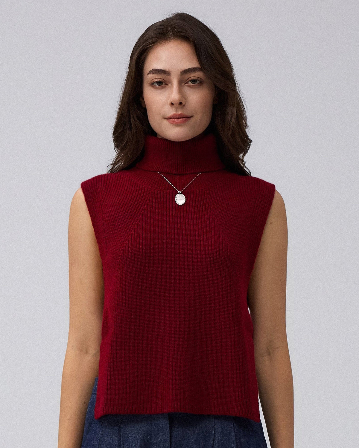 Juana Wool Cashmere Sweater Vest in Pomegranate (wool–cashmere) styled in an elevated layered look with the high neckline visible.