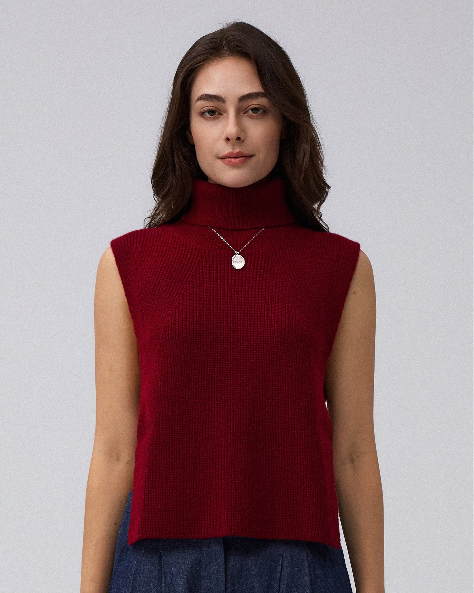 Juana Wool Cashmere Sweater Vest in Pomegranate (wool–cashmere) styled in an elevated layered look with the high neckline visible.