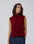 Juana Wool Cashmere Sweater Vest in Pomegranate (wool–cashmere) worn on a model in a front view with the open-side silhouette visible.