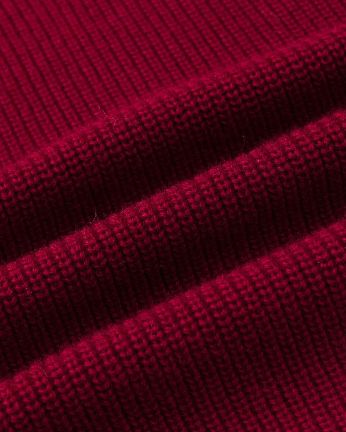 Juana Wool Cashmere Sweater Vest in pomegranate (wool–cashmere) shown in a textile close-up highlighting the heavyweight chunky rib knit.