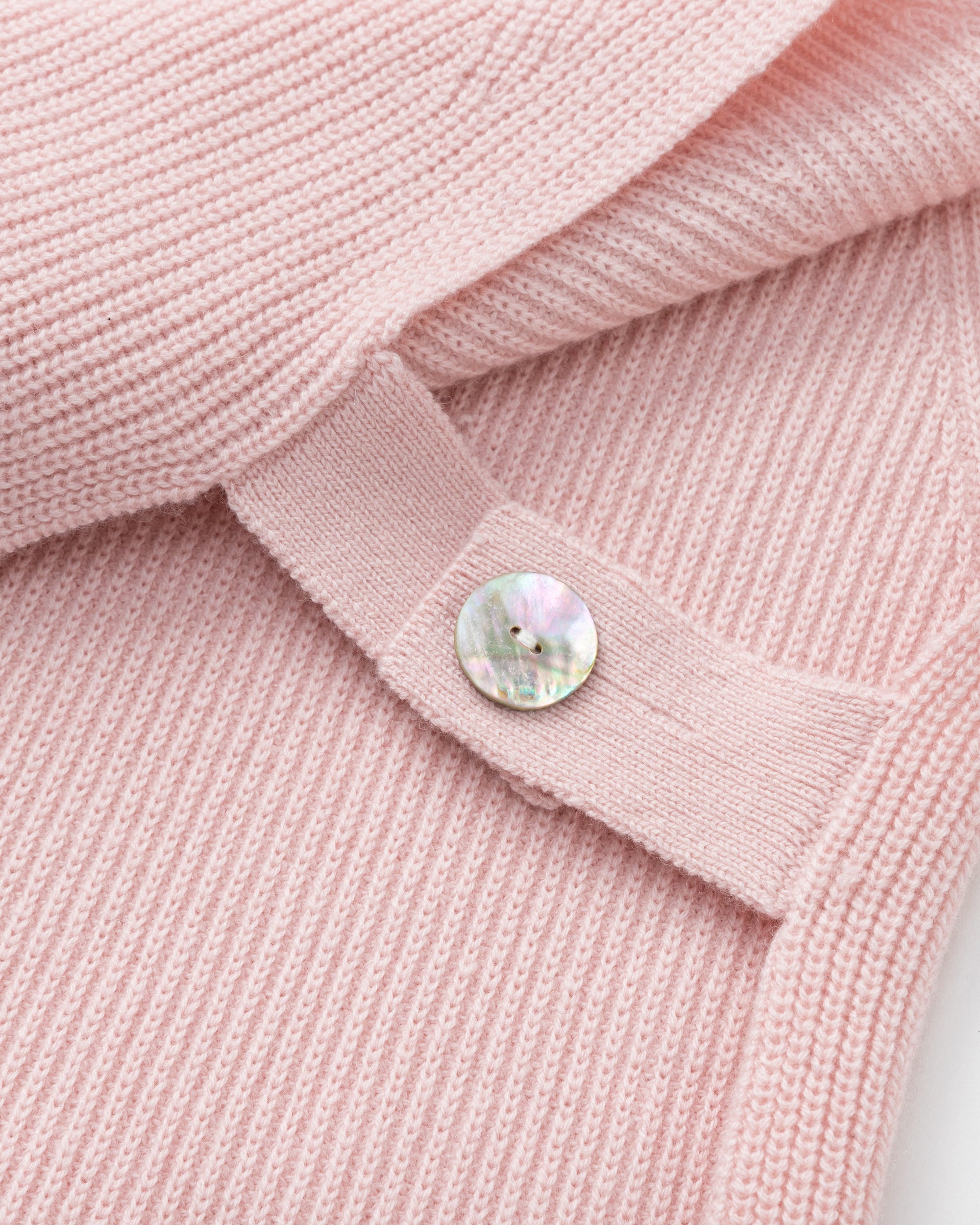 Juana Wool Cashmere Sweater Vest in Rose (wool–cashmere) shown in a detail layflat with adjustable abalone shell side straps.