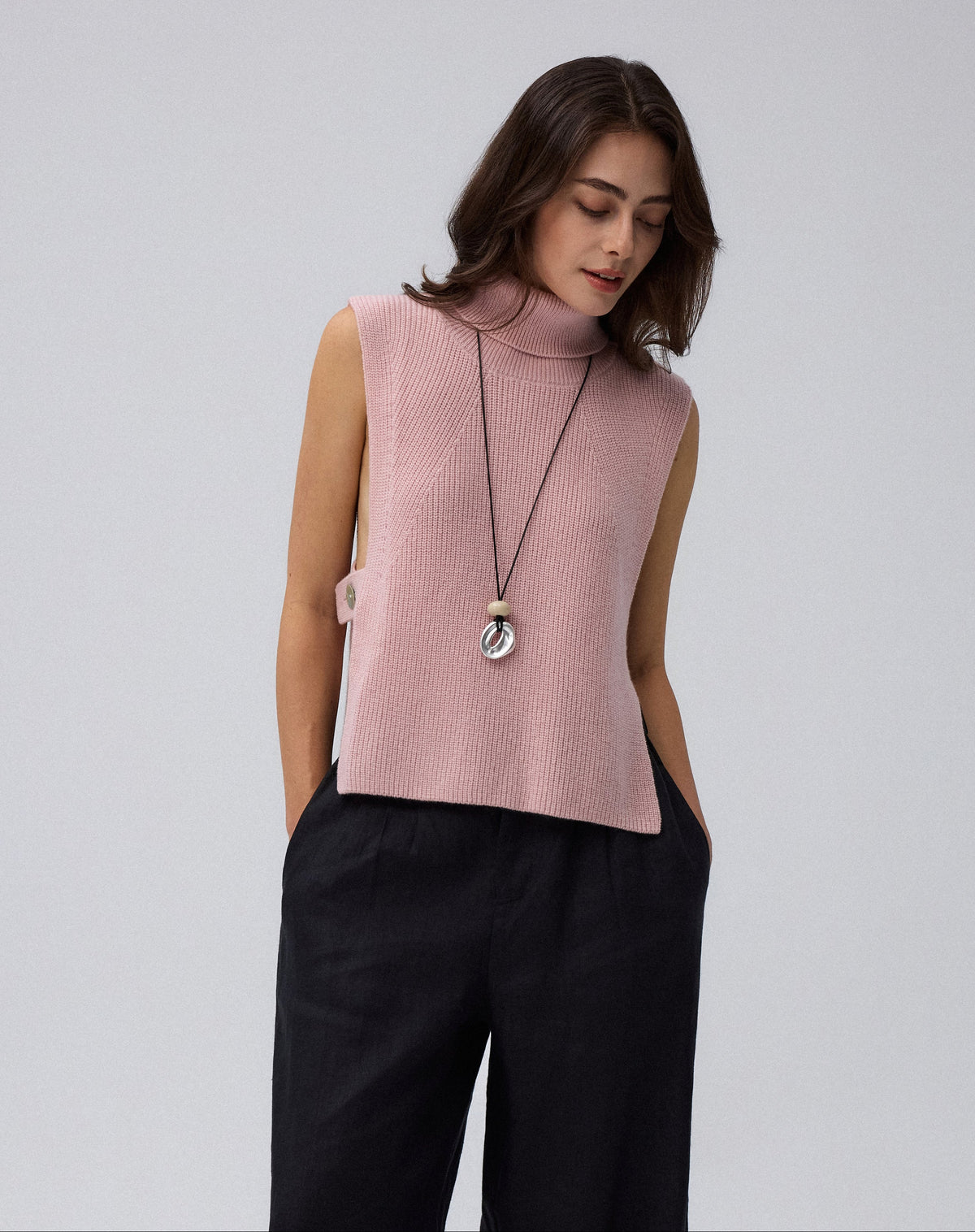 Juana Wool Cashmere Sweater Vest in Rose (wool–cashmere) styled over a lightweight shirt with the shell side straps visible.