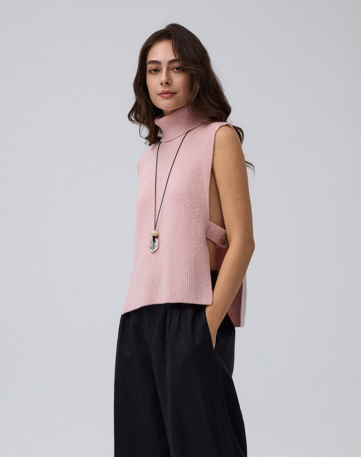 Juana Wool Cashmere Sweater Vest in Rose (wool–cashmere) worn on a model in a front view with the open-side silhouette visible.