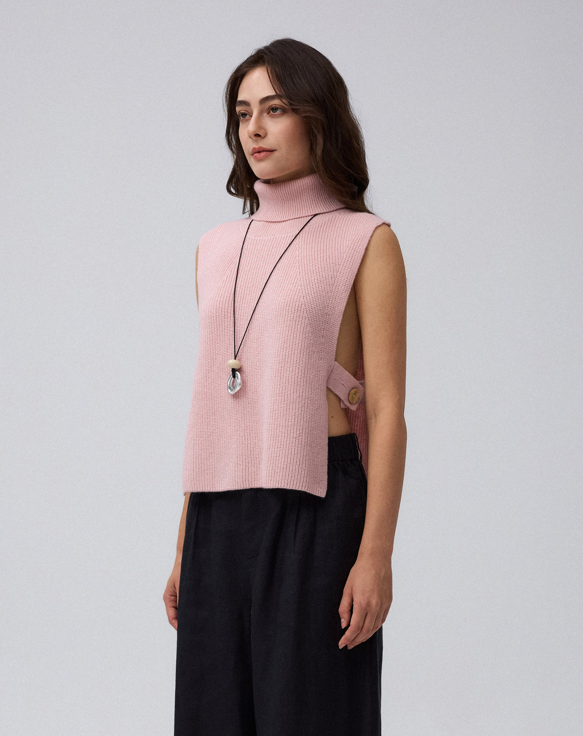 Juana Wool Cashmere Sweater Vest in Rose (wool–cashmere) worn in a side view showing the open side and adjustable strap.