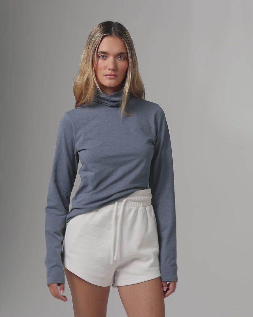 360° video of model wearing the Mockneck (blue), showing fit, drape, and movement.