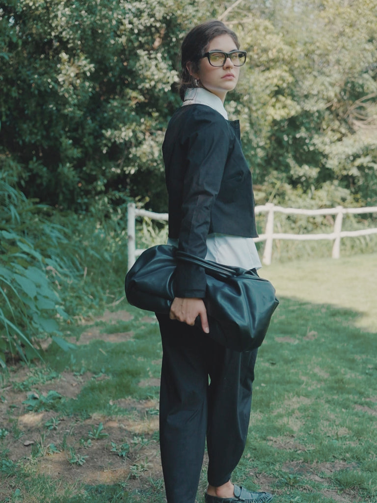 360-degree view of the Juana Aella Woven Top and Tapered Pants Set in black, made from an organic cotton and hemp blend, showing fit, drape, and movement.