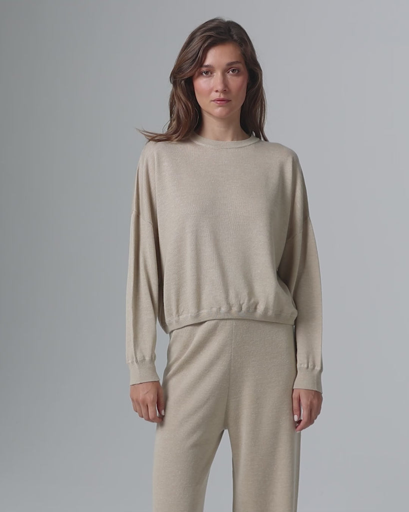 360-degree video of model wearing Nilo Knitted Hemp Crewneck (beige), showing fit and movement.