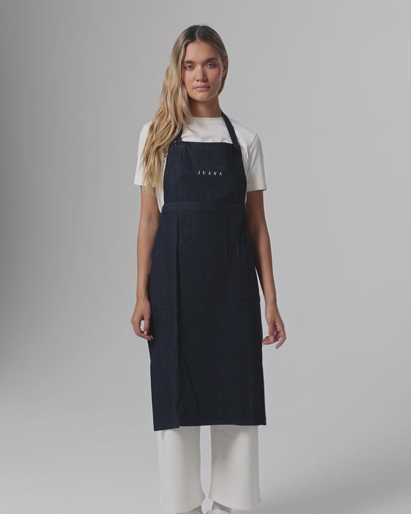 360° video of model wearing Denim Atelier Functional Apron (indigo), showing fit, strap adjustment, and pocket placement.