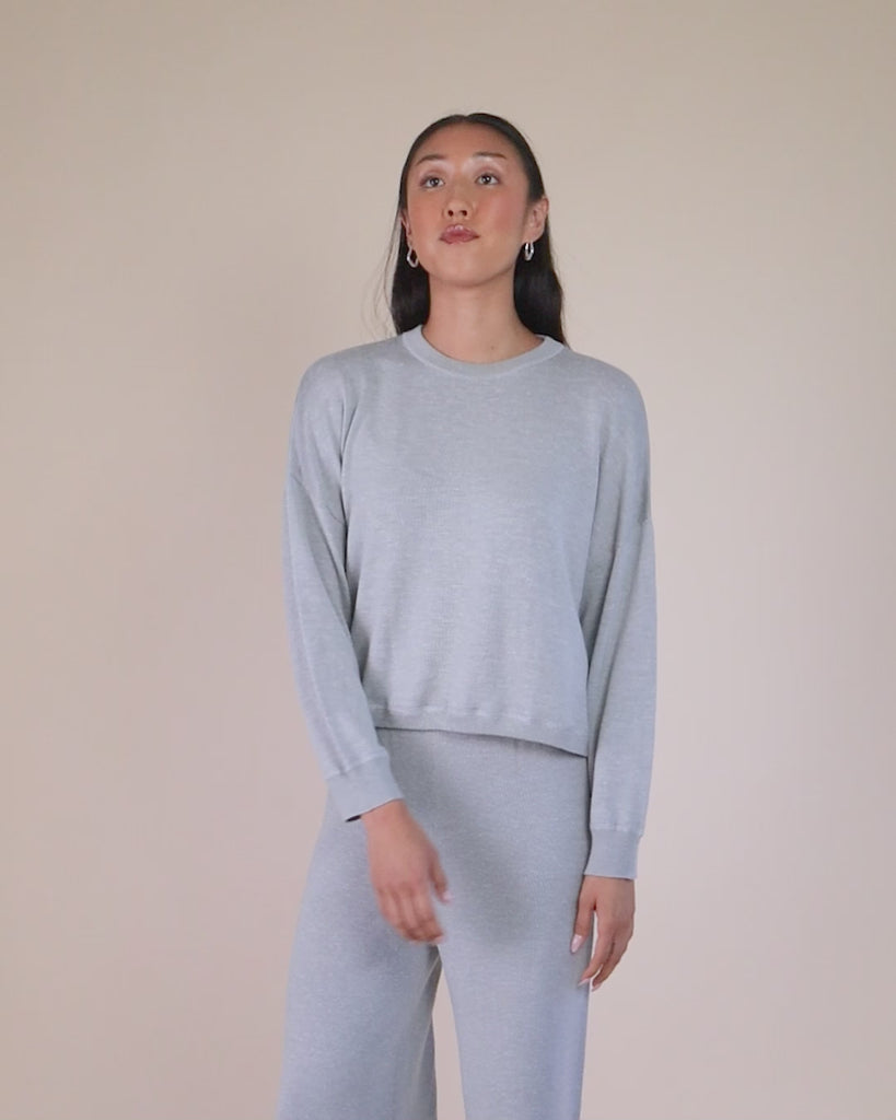 360-degree video of model wearing Juana Nilo Knitted Hemp Crewneck sweater, highlighting all design angles.