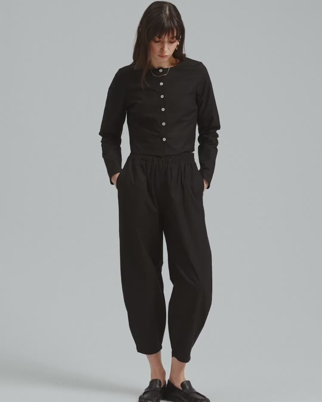 360-degree view of the Juana Aella Woven Top and matching Aella Pants Set in black, made from an organic cotton and hemp blend.