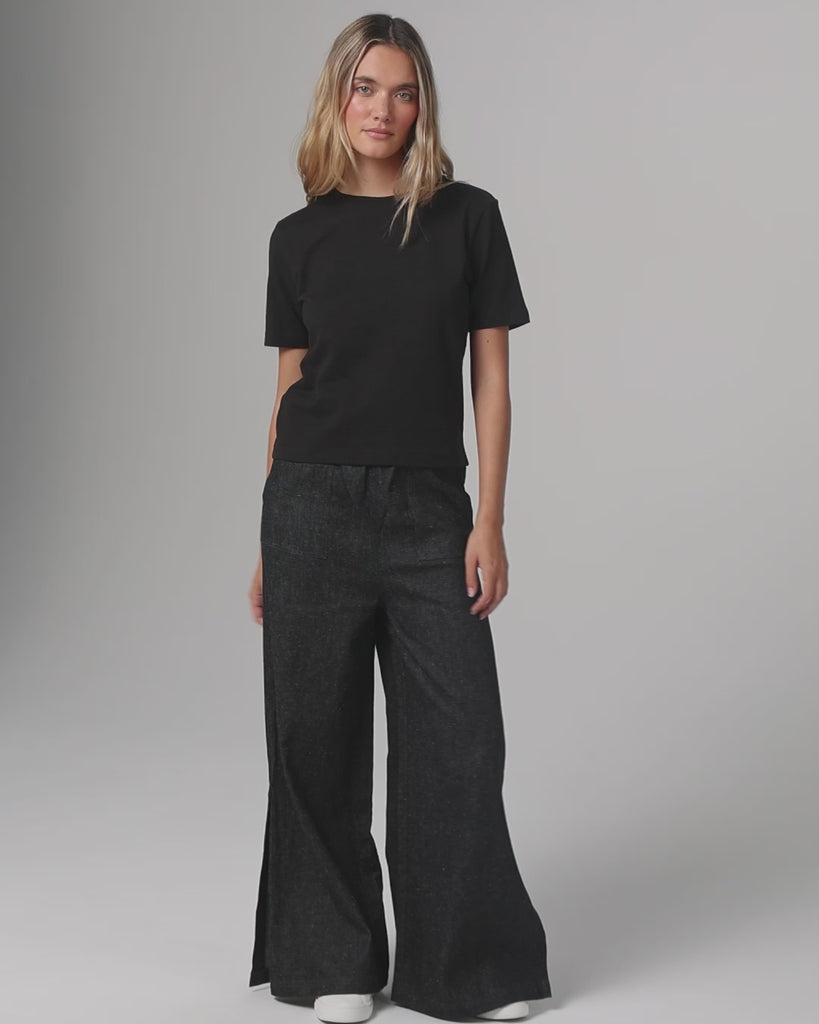 360° video of model wearing Short Sleeve Tee (black), showing fit, drape, and movement.