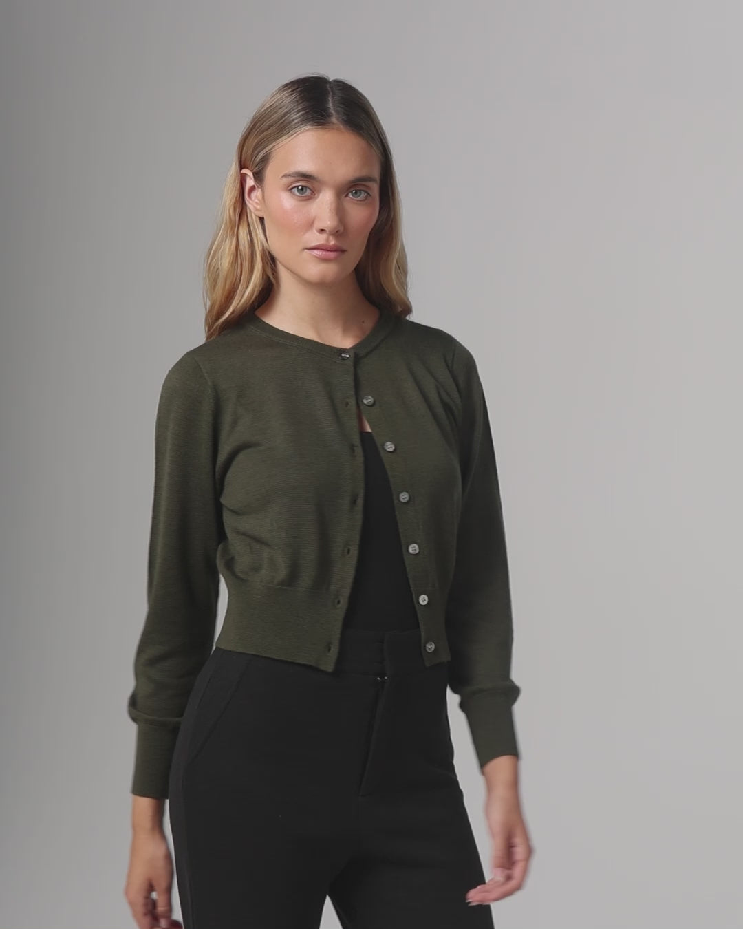 360-degree video of model wearing the Liora Knitted Hemp Cardigan (camo green), showing fit, drape, and movement.